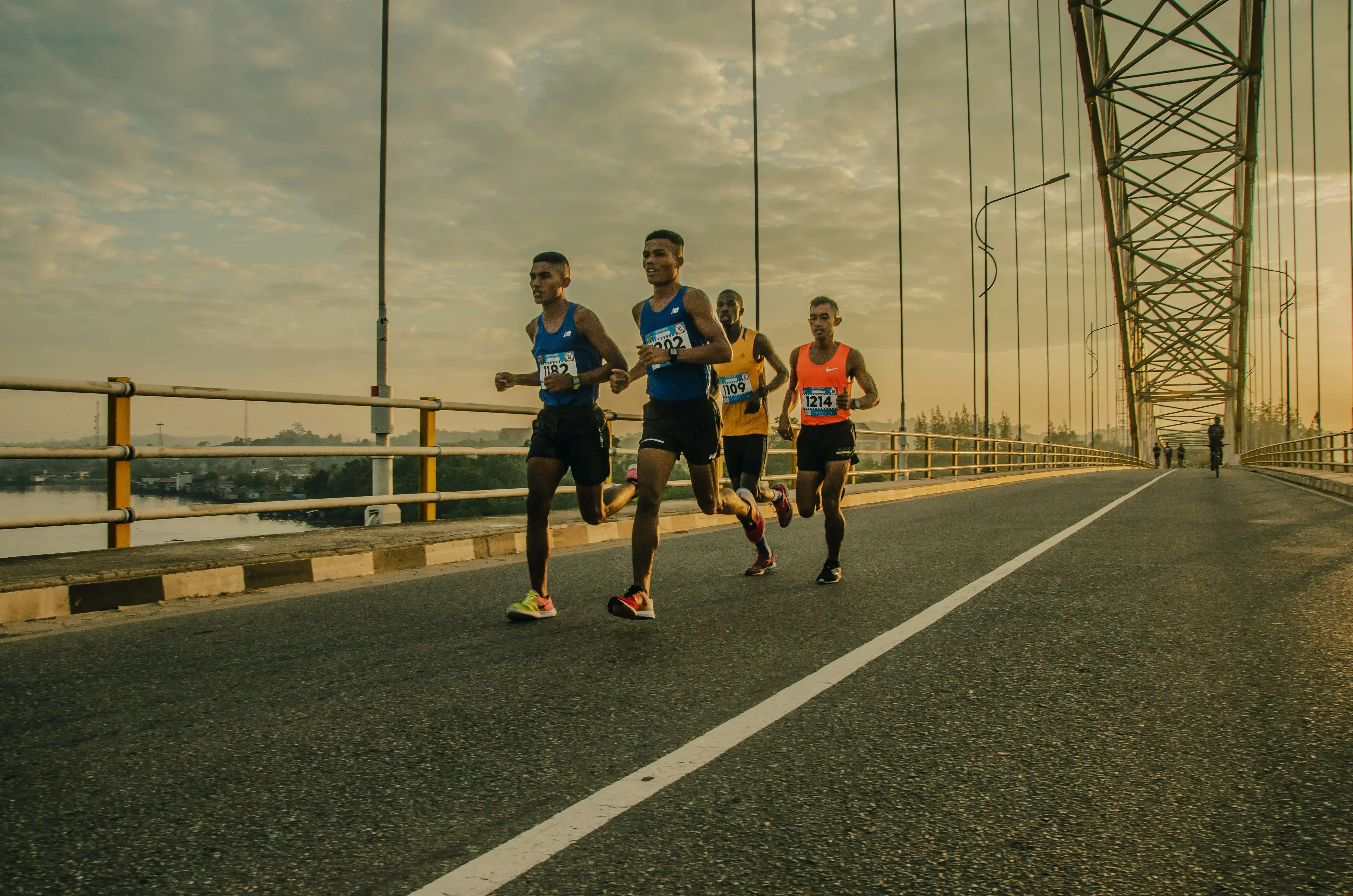 Long distance runner on a road in early morning light
