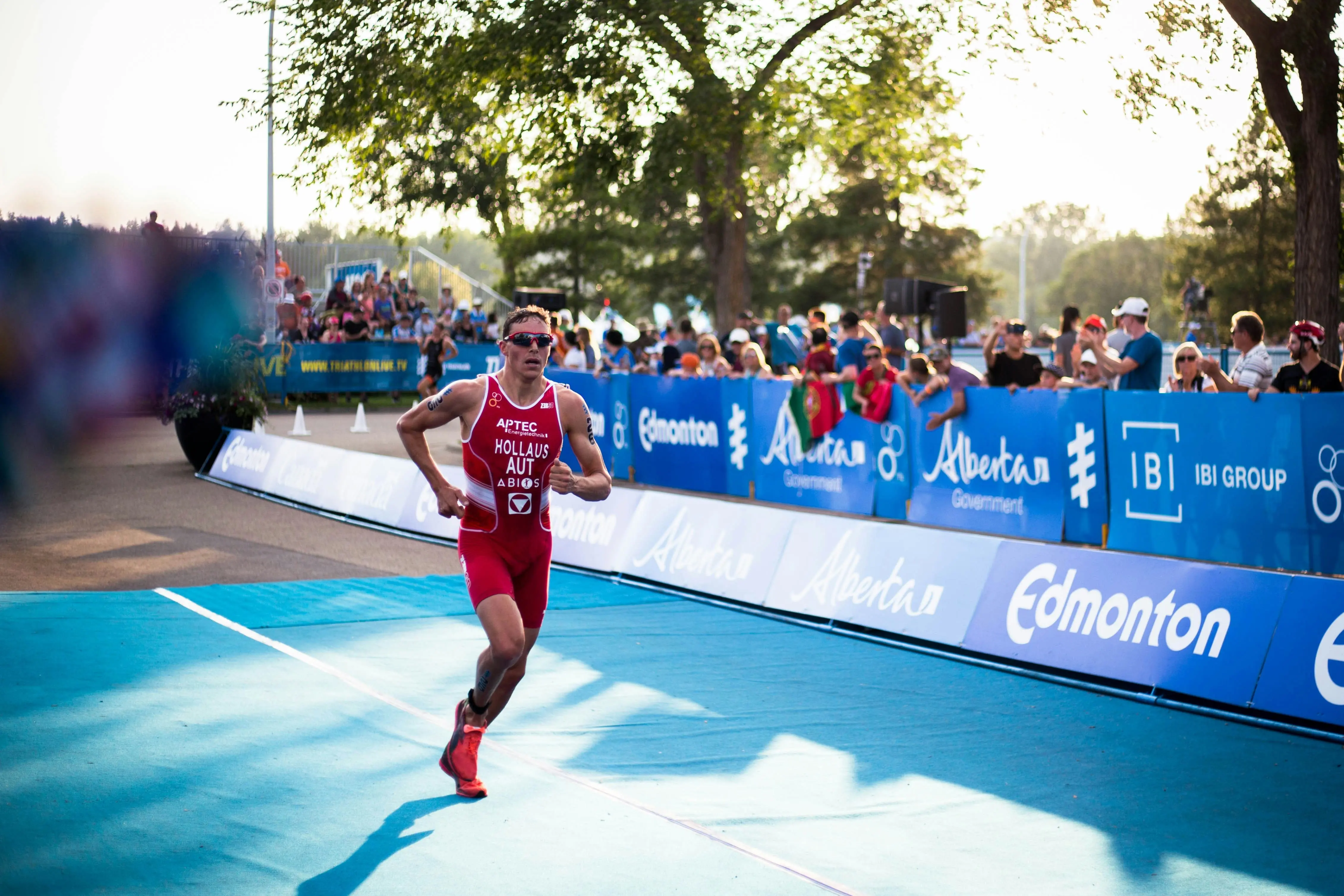 Triathlete running out of the water in a wetsuit during a race